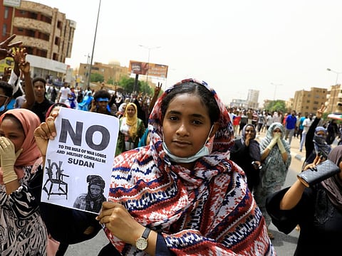 A Sudanese woman holds a placard during a demonstration in Khartoum on June 30.