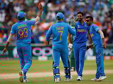 India's Bhuvneshwar Kumar celebrates with team mates after taking the wicket of Bangladesh's Mashrafe Mortaza