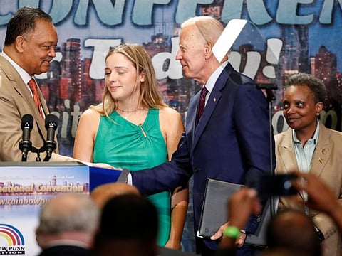 Democratic 2020 US presidential candidate and former vice-president Joe Biden (second right) is greeted on stage by Rev. Jesse L. Jackson (left) before speaking at the Rainbow PUSH Coalition Annual International Convention Labour Luncheon as Mayor of Chicago Lori Lightfoot (right) looks on, in Chicago, Illinois, on June 28, 2019.