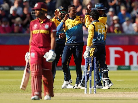 Sri Lanka's Angelo Mathews celebrates with team mates after taking the wicket of West Indies' Nicholas Pooran.