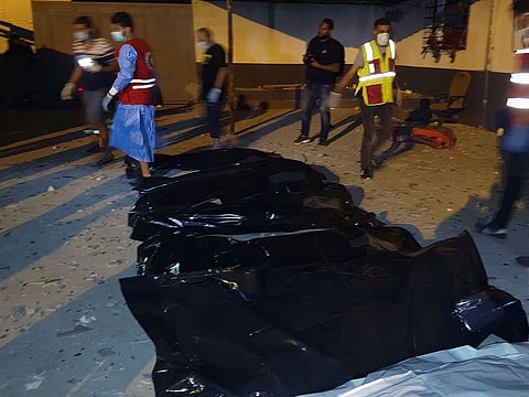 Emergency workers recover bodies after an airstrike killed nearly 40 at Tajoura Detention Center, east of Tripoli on early July 3, 2019.