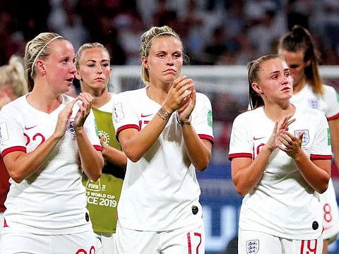England's Rachel Daly and team mates applaud fans after the match.