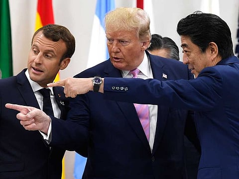 French President Emmanuel Macron, President Donald Trump as Japanese Prime Minister Shinzo Abe speak before a working session at the G-20 summit in Osaka, Japan, on June 28, 2019.