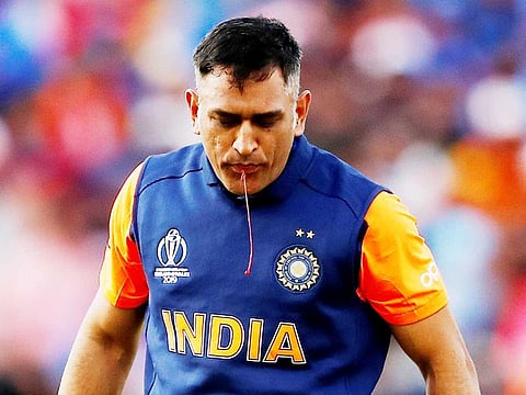 India's MS Dhoni spits out blood after sucking his cut thumb during the match against England at Edgbaston, Birmingham, on June 30, 2019.