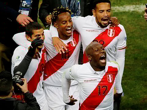 Peru's Luis Advincula celebrates after the match with team mates.