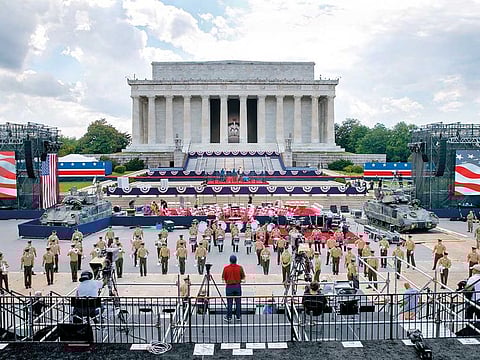 Two Bradley Fighting Vehicle’s flank the stage being prepared in front of the Lincoln Memorial in Washington, ahead of Fourth of July festivities.