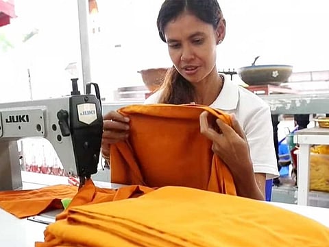 Some 30 plastic polyethylene terephthalate (PET) litre-and-a-half bottles are needed to make each set of robes, made up of 30 or 35 per cent recycled materials, while the rest is cotton and other materials.