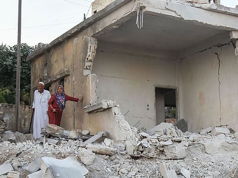 Syrians inspect the damage following reported regime airstrikes on the town of Muhambal, in the northern Idlib province.