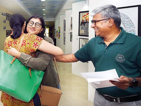 Anuja Venkataramani, with her mother and father Usha Venkataramani and R Venkataramani, celebrate after receiving her IB results