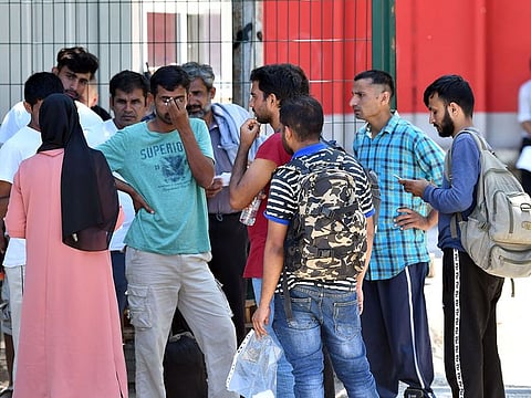 A group migrants gather at the gate of the "Bira" migrants and refugees camp, in Bihac, in Northern Bosnia.