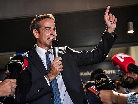 Greece's newly elected Prime Minister and leader of conservative New Democracy party Kyriakos Mitsotakis, speaks to the press outside the party's headquarters after the official results of the elections, in Athens on July 7, 2019.