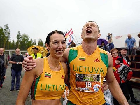 Lithuanian couple Vytautas Kirkliauskas, right, and Neringa Kirkliauskiene celebrate their victory in the wife carrying race, a 278-yard obstacle course, during the 24th world championships in Sonkajarvi, Finland, Saturday, July 6, 2019.