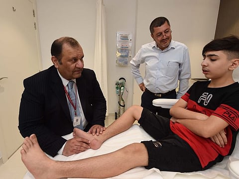 Dr.Nadeem Akhtar, Consultant Plastic Surgeon of Al-Zahra Hospital Sharjah, checking Mustafa Sawas heel also seen his father Eamd Sawas at Al-Zahra Hospital Sharjah on 01 JULY 2019 photo; Atiq Ur Rehman /Gulf News