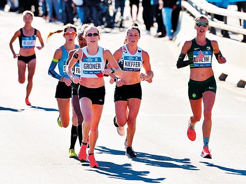 Elite women runners in the 2018 TCS New York City Marathon hit the 13.1 mile marker on the Pulaski Bridge in Brooklyn.