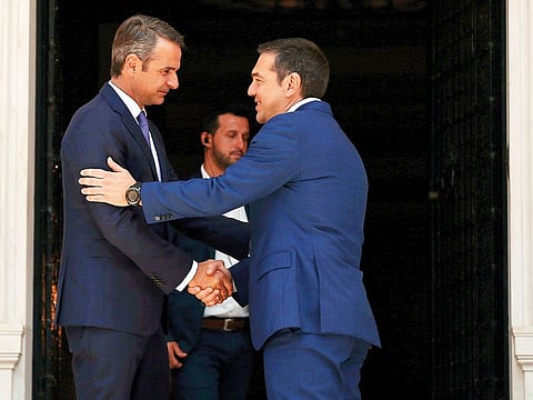 New Greek PM Kyriakos Mitsotakis (left) with outgoing PM Alexis Tsipras.