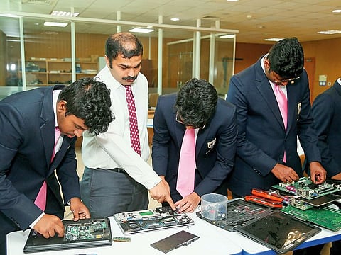 Basheer Ahmad guides students in repairing the devices at GEMS Modern Academy in Nad Al Sheba.