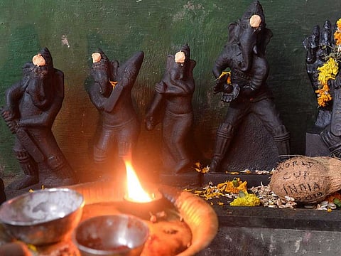 Statues of 'Ganesha' (the elephant-headed deity) carved with cricket equipment are seen on the occasion of the cricket World Cup at a temple in Chennai on July 9, 2019.