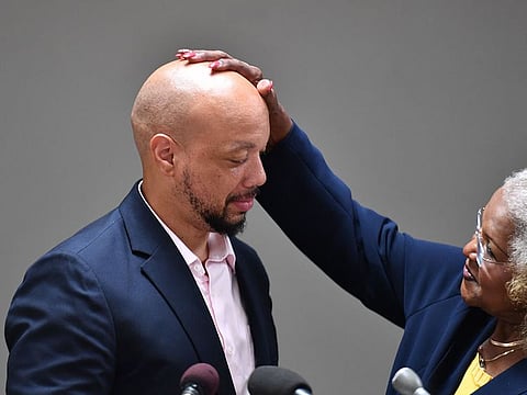 Maryland Sen. Joanne Benson, a Democrat, gives former pupil Curtis Brooks a pat on the head at St. Margaret's Catholic Church in Capital Heights, Maryland.