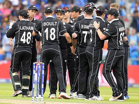 New Zealand's captain Kane Williamson (C) and teammates celebrate victory during the World Cup semi-final against India at Old Trafford in Manchester.