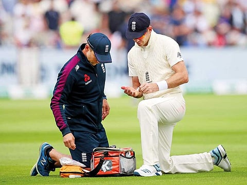 England bowler James Anderson receives medical attention during the first day of the first Ashes Test at Edgbaston in Birmingham on Thursday.