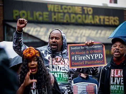 People protest outside the police headquarters while a disciplinary hearing takes place for officer Daniel Pantaleo in New York City, earlier this year.