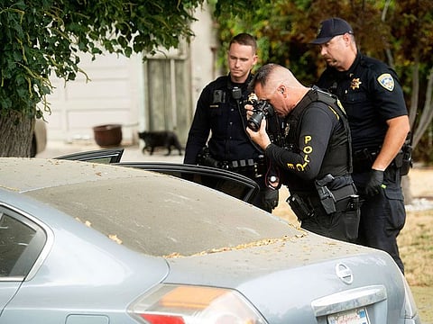 A police officer photographs a car outside the family home of Gilroy Garlic Festival gunman Santino William Legan on Monday, July, 29, 2019, in Gilroy, Calif.