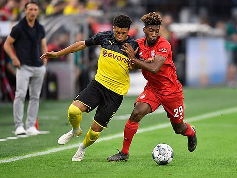 Bayern's Kingsley Coman, right, duels for the ball with Dortmund's Jadon Sancho during the German Supercup final soccer match in Dortmund, Germany, on Saturday.