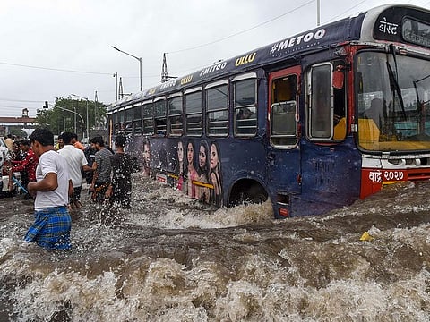 A public bus makes its way on a flooded road after heavy monsoon rains in Mumbai on August 4, 2019.