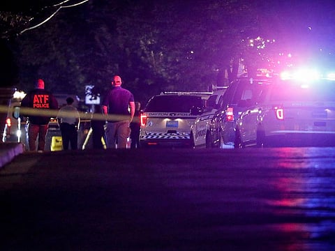 Authorities work at the scene of a mass shooting, on Sunday, in Dayton, Ohio.