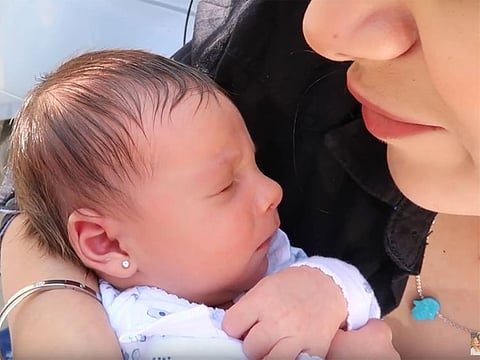 Video grab of mother with the sleeping baby