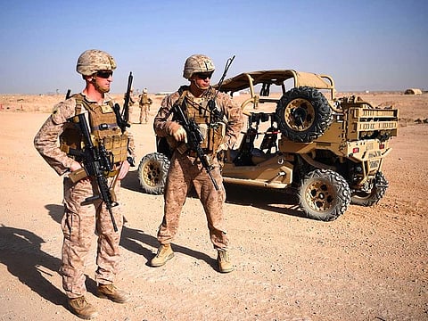 US Marines keep watch as unseen Afghan National Army soldiers participate in an IED (improvised explosive device) training exercise at the Shorab Military Camp in Lashkar Gah in the Afghan province of Helmand.