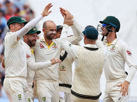Australia's Nathan Lyon (centre) celebrates after taking the wicket of England's Stuart Broad during the match.