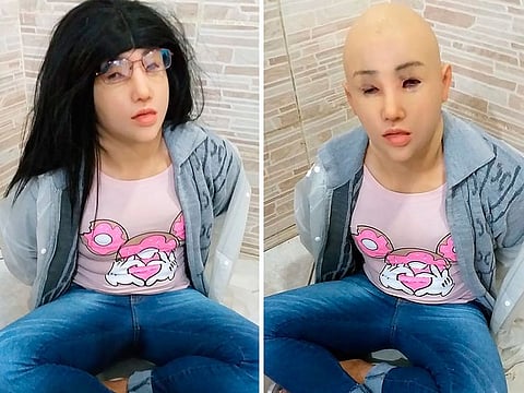 A man who authorities identify as jailed Brazilian drug trafficker Clauvino da Silva, alias 'Baixinho,' which means 'Shorty,' wearing a mask, wig, glasses and feminine clothing, as his hands are confined behind his back at a prison complex in Rio de Janeiro.