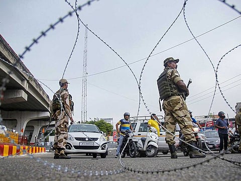 Security personnel stand guard during restrictions, in Jammu, Monday, Aug 05, 2019.