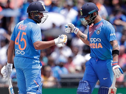 India's Rohit Sharma, left, bumps fist with Virat Kohli, right, during the first Twenty20 international cricket match against the West Indies, in Lauderhill, Florida.