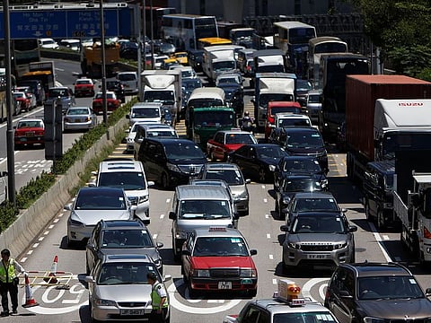 Traffic is seen as workers remove barricades that were placed by protesters to block the road, at the Cross-Harbour Tunnel in Hong Kong, China August 5, 2019