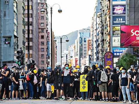 Demonstrators stand off against riot police during a protest in the Tism Sha Tsui district of Hong Kong, China.