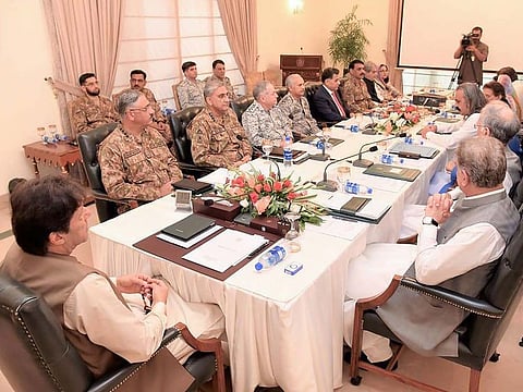 In this handout picture released by Press Information Department (PID) on August 4, 2019, Pakistan Prime Minister Imran Khan (L) chairs the National Security Committee meeting in Islamabad.