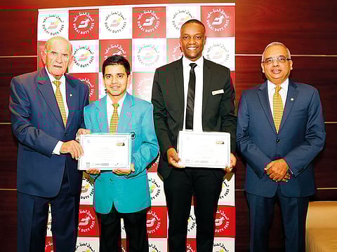 DDF employees Binaya Regmi and Reuben Wanjiku being felicitated by Colm McLoughlin and Ramesh Cidambi.