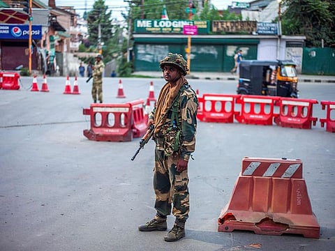 In this picture taken on August 6, 2019 security personnel stand guard on a street in Srinagar. Kashmir was stripped of its seven-decade-long autonomous status through a controversial presidential decree on August 5, a day after a crippling curfew was imposed on its main city