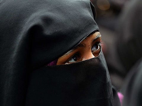 Illustrative image: A Muslim woman looks on a celebration for the passage of a law to outlaw Triple Talaq, or "instant divorce."