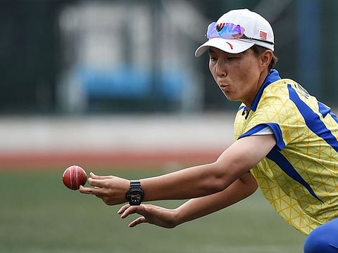 Shanghai's Wang Meng trying to catch a ball off the Hong Kong batting during their cricket match in Shanghai on July 28, 2019.