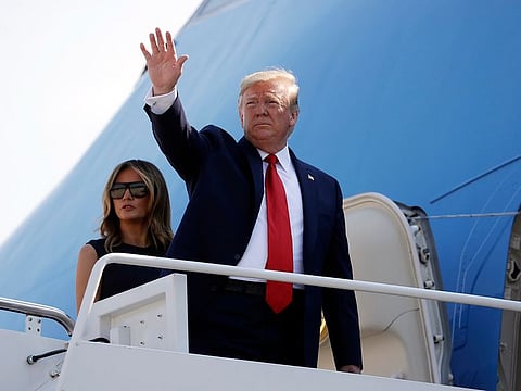 President Donald Trump and first lady Melania Trump board Air Force One.