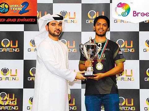 Arslan Ash receives the trophy after winning 2018 gaming tournament in UAE.