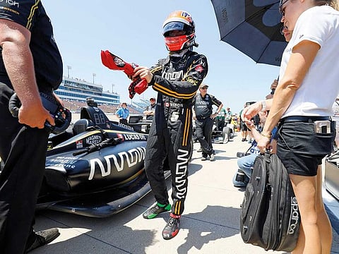 James Hinchcliffe stands next to his car during qualifying for the IndyCar Series auto race at Iowa Speedway in Newton, Iowa.