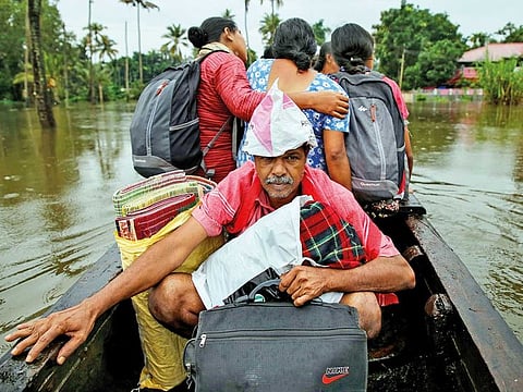 Flood-affected people are moved to a safer place in Paravur in Ernakulam district in the southern state of Kerala.