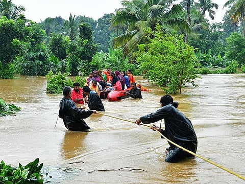 Rescue personals evacuate families affected by floods at Eloor, in Ernakulam district, in the Indian state of Kerala.