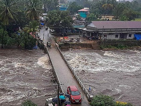 Flood water rushes from under the Kovilkadav Bridge, in Munnar