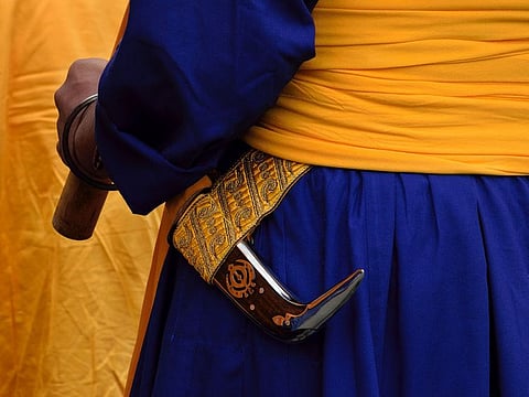 Sikh man carrying a ceremonial dagger called 'kirpan.' For illustrative purposes only.