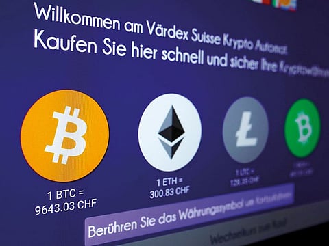 Exchange rates and logos of Bitcoin (BTH), Ether (ETH), Litecoin (LTC) and Bitcoin Cash (BCH) are seen on the display of a cryptocurrency ATM in Zurich.